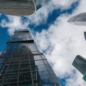 Modern corporate buildings against blue cloud sky in winter cold day. High-rise buildings in Moscow city. low angle view